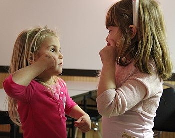 Girls learning the American Sign Language.